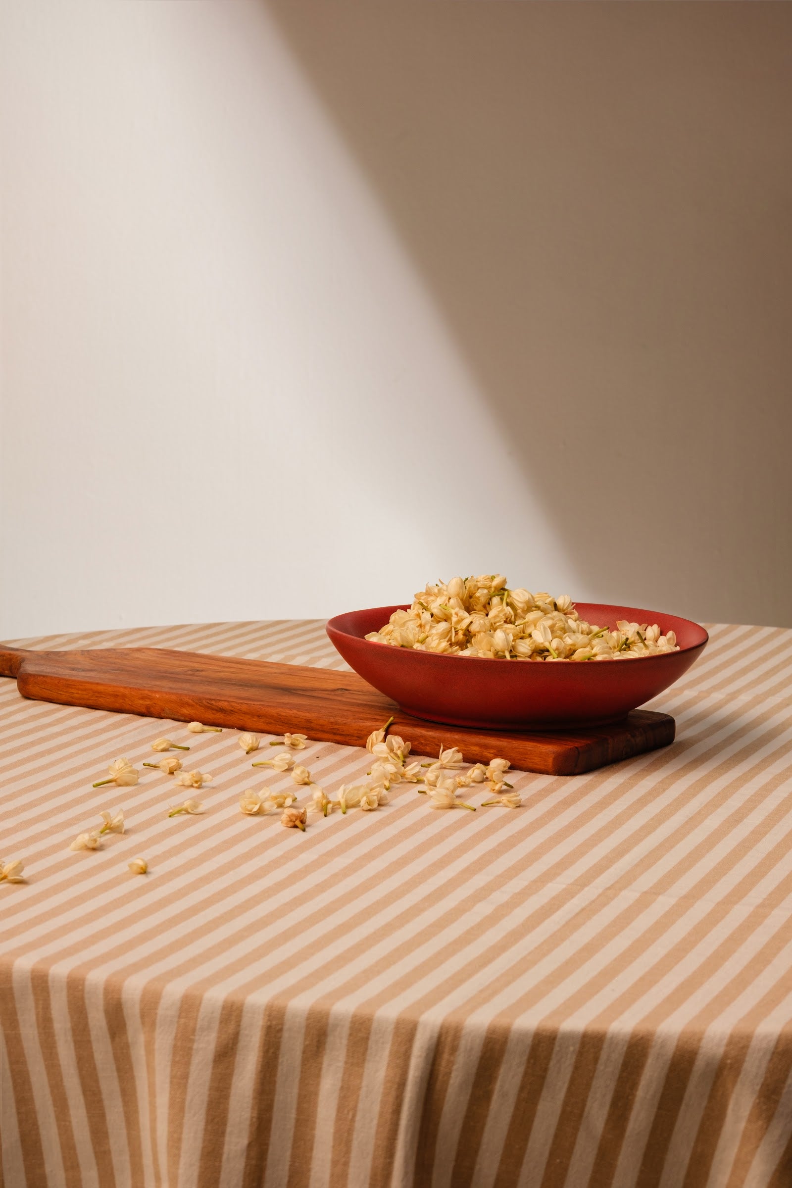 A single handcrafted ceramic bowl in a warm rust glaze, simply styled
